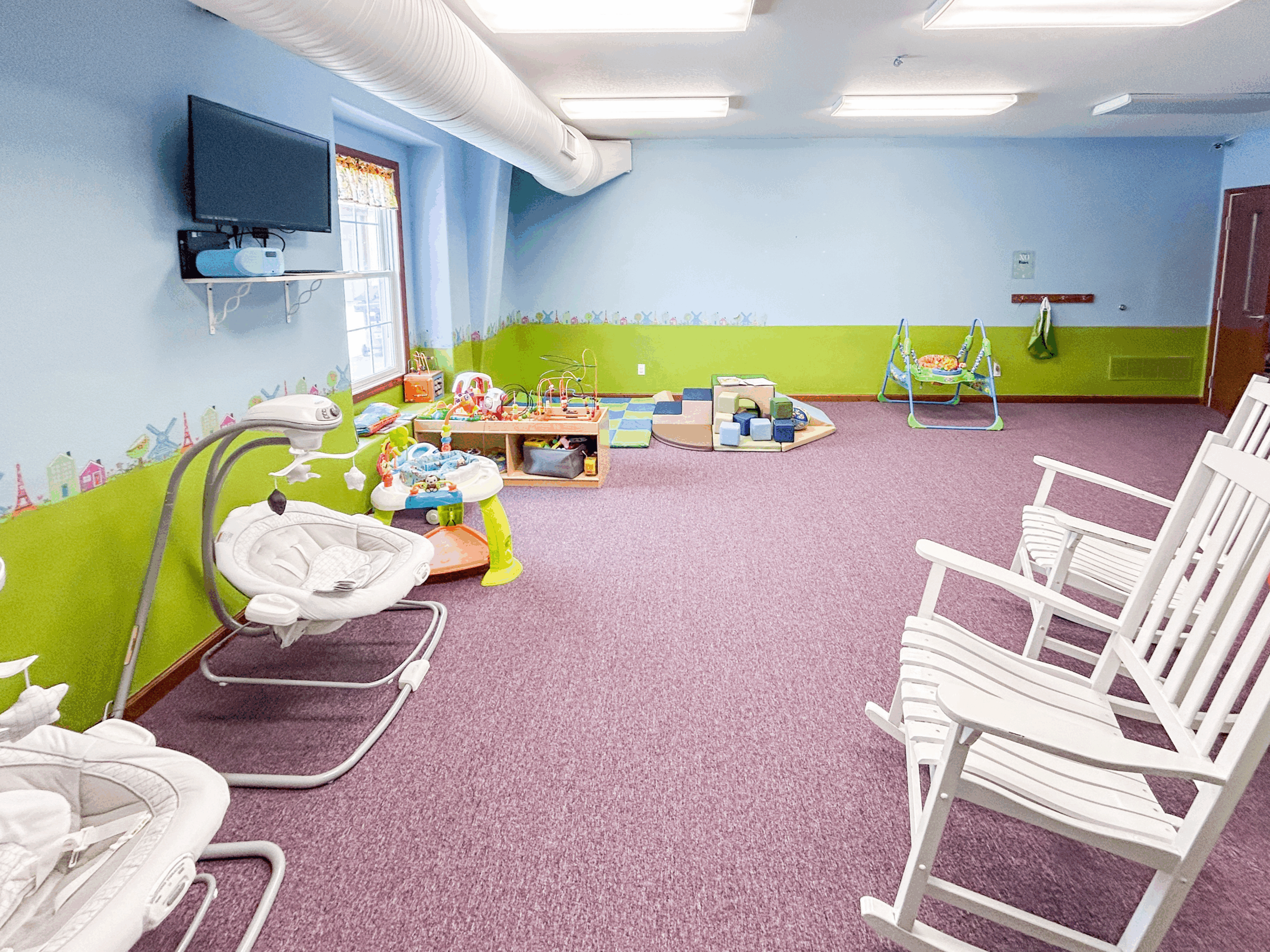people sitting on chair in front of table while holding pens during daytime